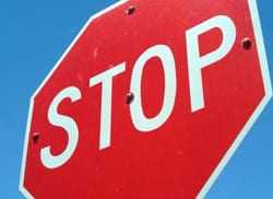 Red stop sign against a blue sky.