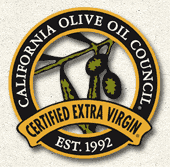California Olive Oil Council certified extra virgin seal with an olive branch and the text “Est. 1992.”