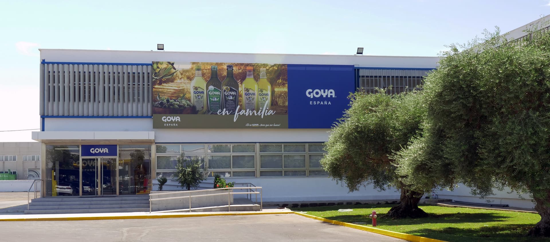Goya España building with a large advertisement promoting their products and a landscaped entrance.