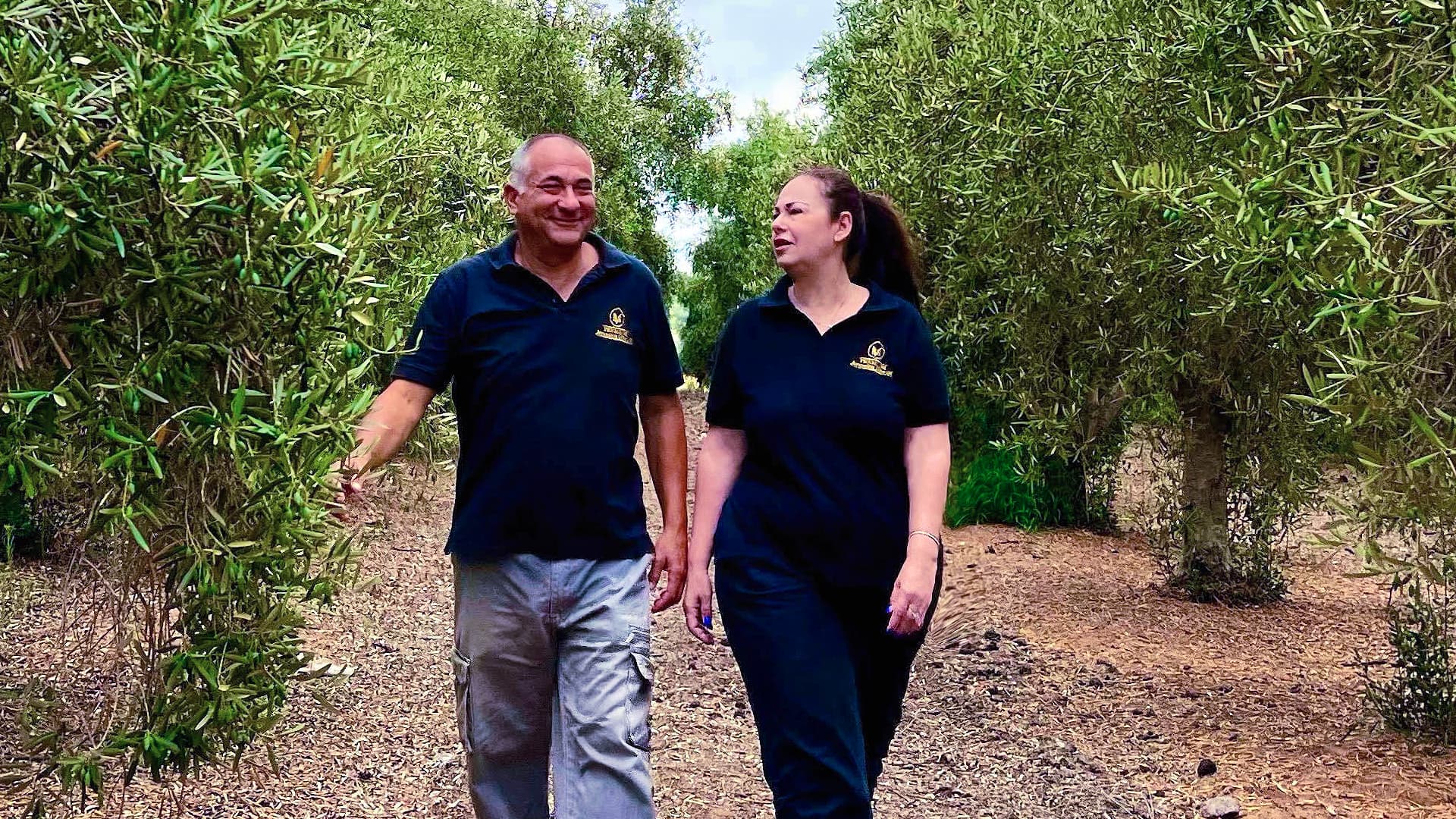 Jerusalem Olive Oil co-owners Moosh and Hanzi Askenenazi inspect their grove. (Photo: Jerusalem Olive Oil)