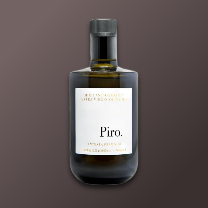 A bottle of Piro extra virgin olive oil with a minimalist label on a dark background.