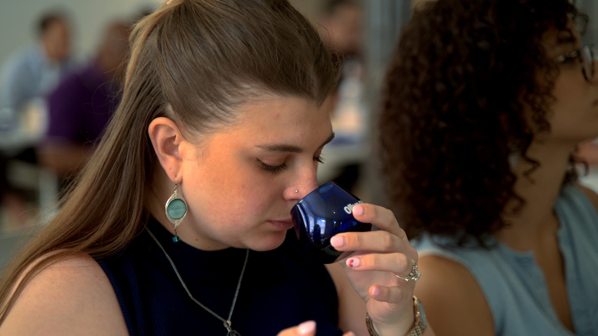 A participant evaluates an olive oil sample during a guided sensory analysis session at the Olive Oil Times Sommelier Certification Program in New York, where students learned to identify aromas, flavors and defects using professional tasting techniques.