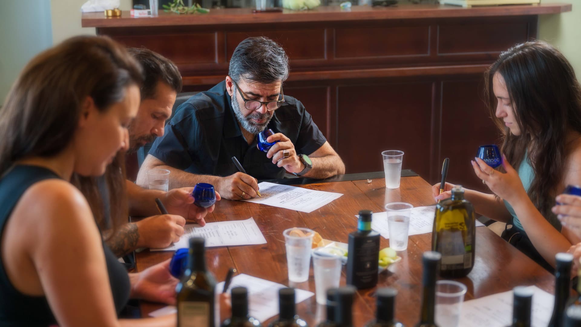 Papadopoulos and his associates assess olive oils during a tasting panel, applying the standards that have helped make The Master Miller one of the world’s most awarded producers.
