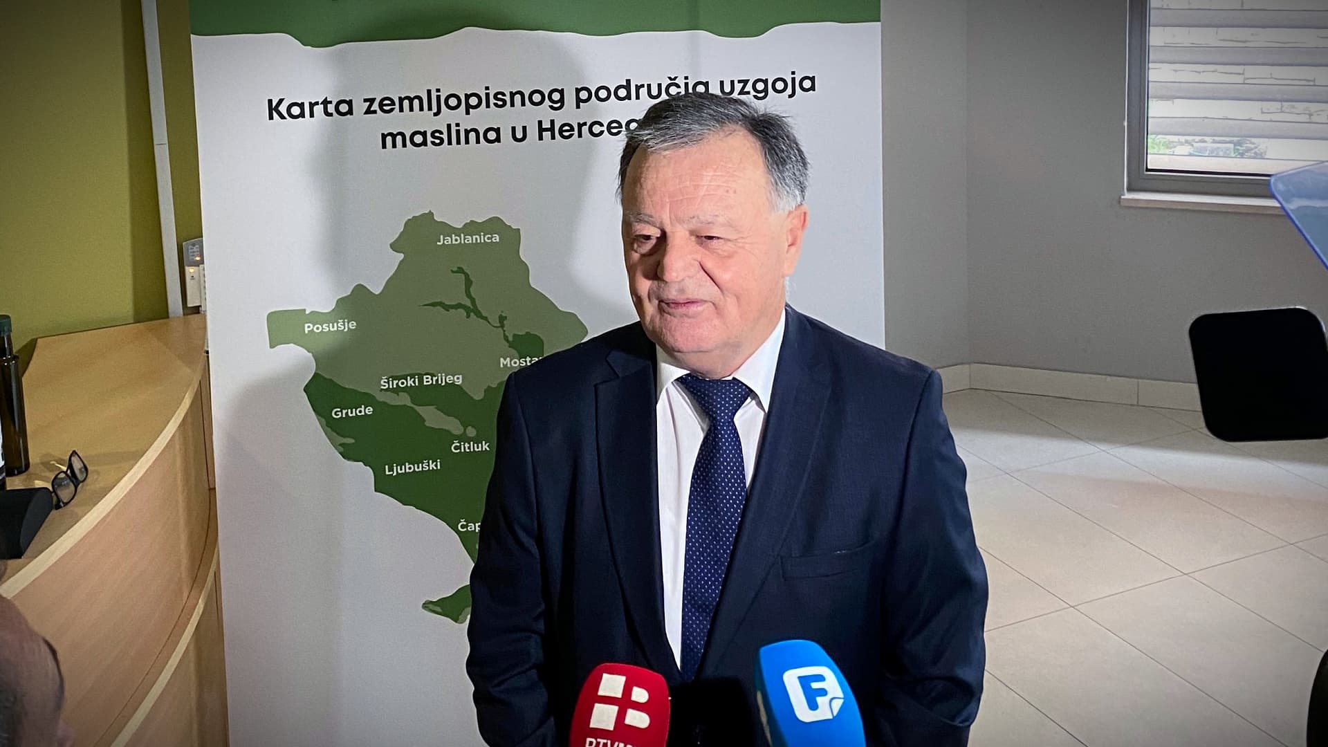 Marko Ivanković, director of the Federal Agro-Mediterranean Institute in Mostar, stands before a map of Herzegovina’s olive-growing areas. Ivanković has been a leading advocate for the region’s expanding olive sector and its goal of reaching 1,000 hectares of groves by 2030.